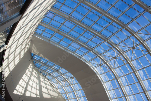 Architectural geometry. Transparent roof with a blue sky view.