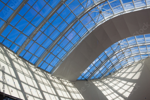 Architectural geometry. Transparent roof with a blue sky view. 