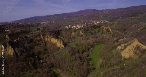 Aerial, Le Balze del Valdarno, giant ancient hills made of sand, clay, argil and gravel situated in Tuscany in Italy and a little town Piantravigne close to them photo