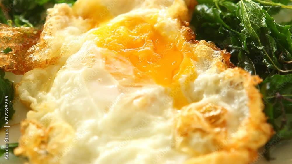 Fried egg with basil in plate Fried egg with basil in plate