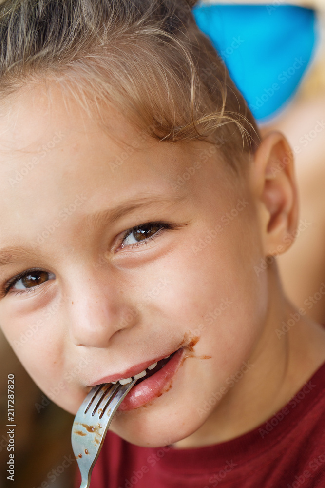 boy eating pancake with banana and chocolate boy eating pancake with banana and chocolate
