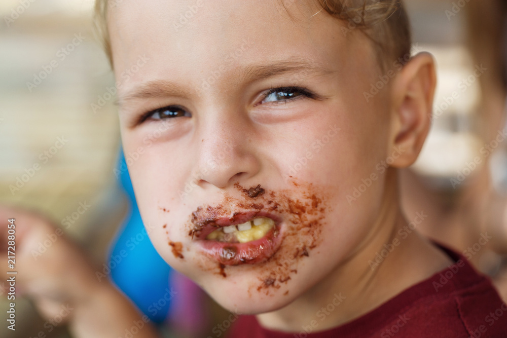 boy eating pancake with banana and chocolate boy eating pancake with banana and chocolate