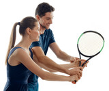 Male coach and female beginner on white. Skillful player showing how to hold a racquet right.