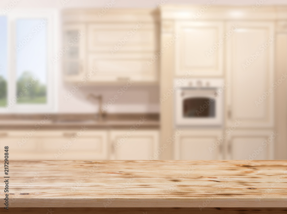Wood table top on blur kitchen room background .For montage product display or design key visual layout. Wood table top on blur kitchen room background .For montage product display or design key visual layout.