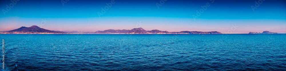 Panorama of Gulf of Naples against mount Vesuvius and Isle of Capri at dusk. Italy