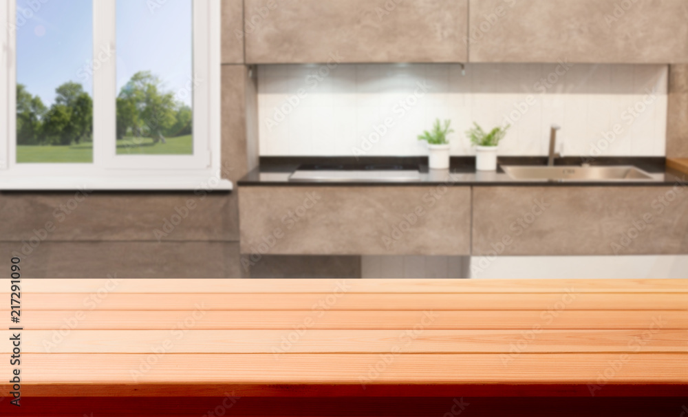 Wood table top on blur kitchen room background .For montage product display or design key visual layout. Wood table top on blur kitchen room background .For montage product display or design key visual layout.