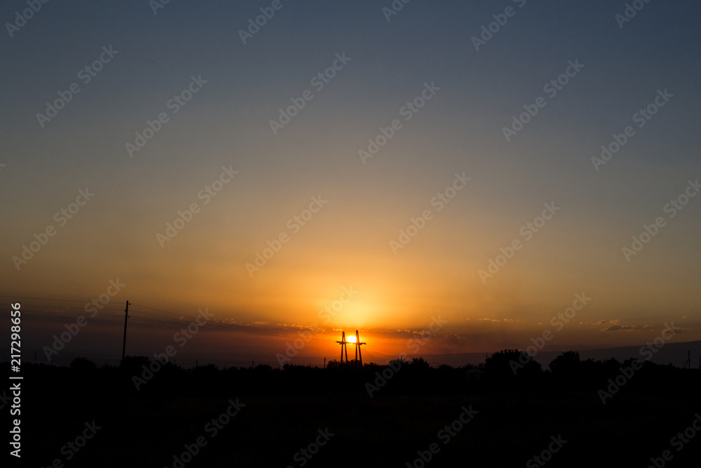 Sunset behind electric tower