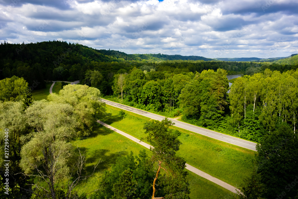 scenic view of blue cloudy sky, road and green trees, Riga, Latvia
