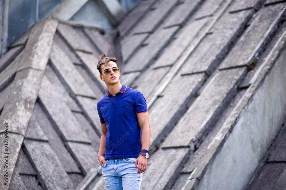 Young fashionable man posing against building Young fashionable man posing against building