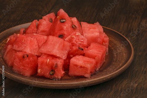 The flesh of watermelon cut into cubes in a clay plate