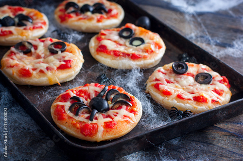 Mini pizza for Halloween with spiders, mummy and spider web, horizontal