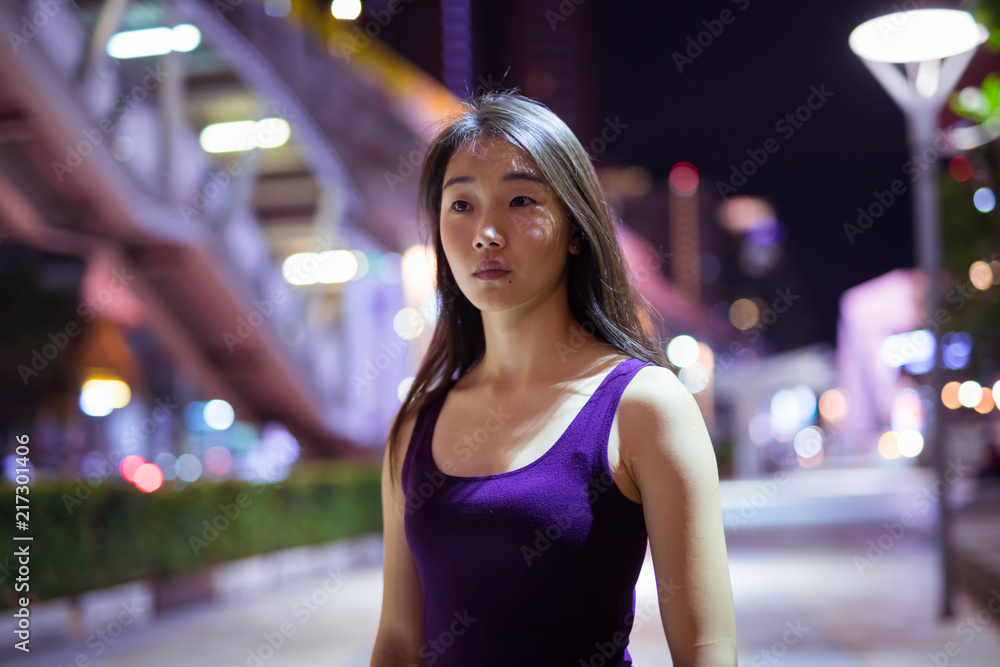 Portrait Of Beautiful Asian Woman Outdoors At Night