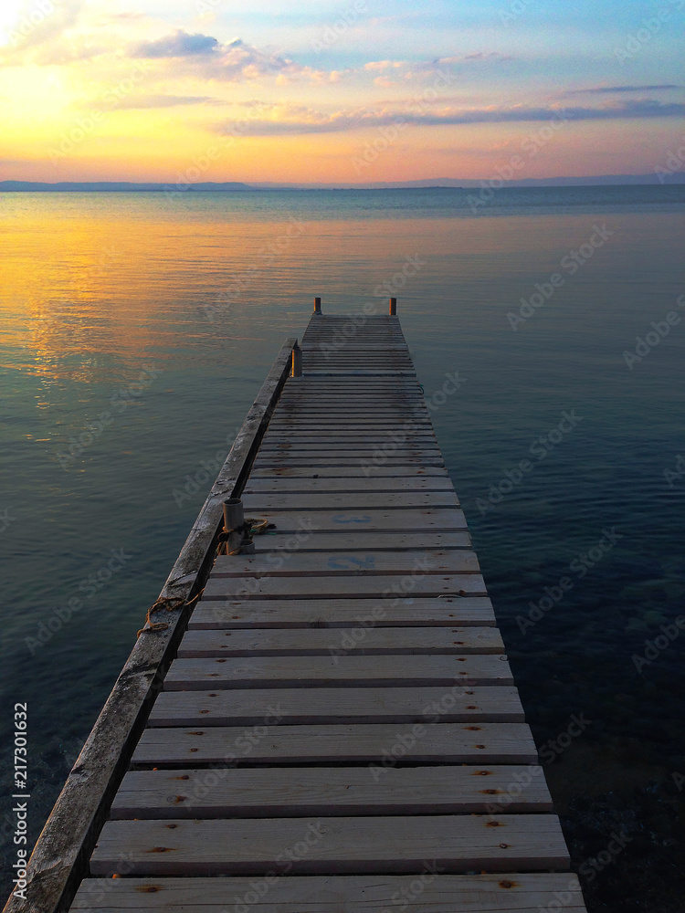a beautiful sunset in the golden hour and background of a beautiful sky and calm water shot with a phone. Landscape of beautiful sunrise sky and beautiful colors. phone photography.