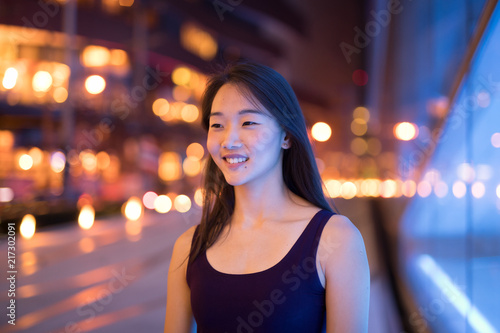 Happy Asian Woman Thinking Outdoors At Night