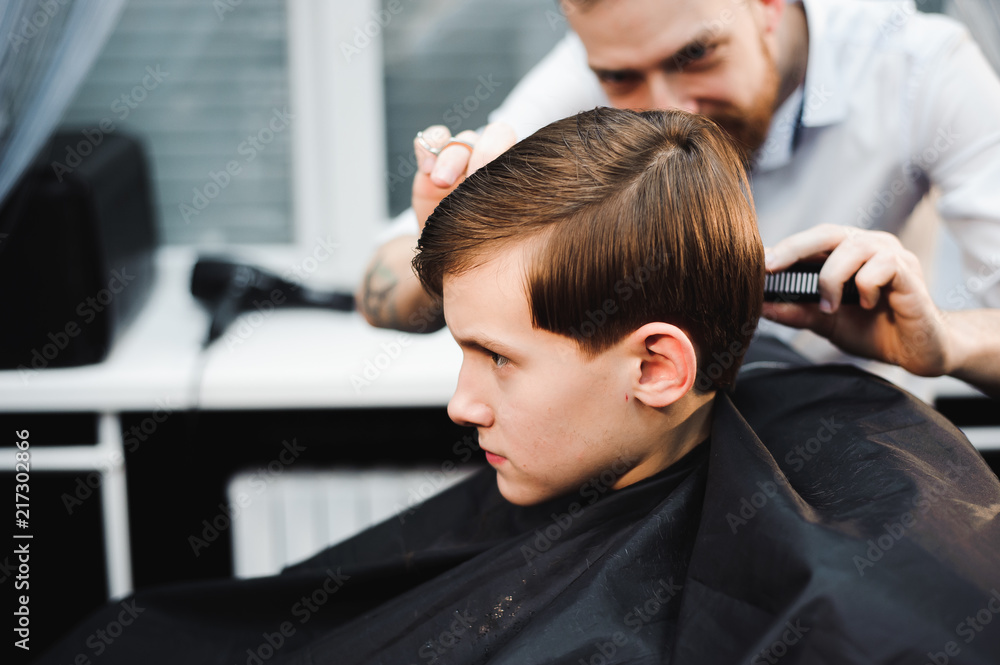 cute young boy getting a haircut cute young boy getting a haircut