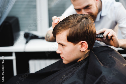 cute young boy getting a haircut