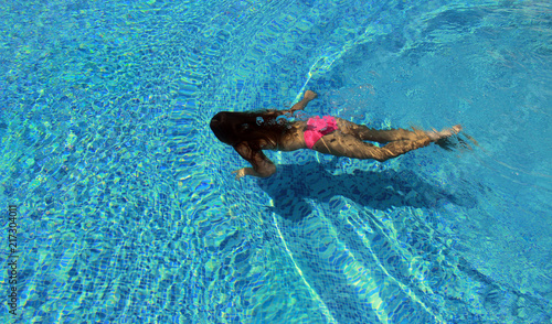 The girl is diving in the pool
