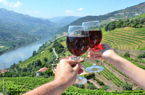 Wine glasses against vineyards in Douro Valley, Portugal photo