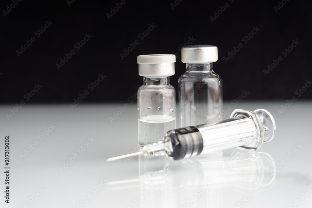 Syringe and vials closeup with selective focus and crop fragment. Medical and Healthcare Concept Syringe and vials closeup with selective focus and crop fragment. Medical and Healthcare Concept