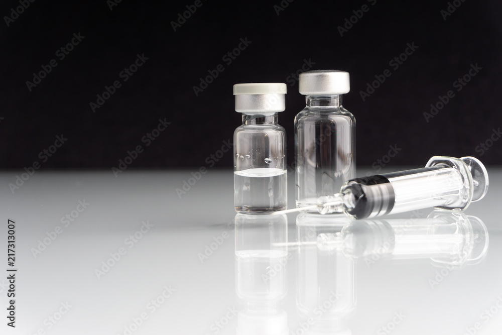 Syringe and vials closeup with selective focus and crop fragment. Medical and Healthcare Concept Syringe and vials closeup with selective focus and crop fragment. Medical and Healthcare Concept