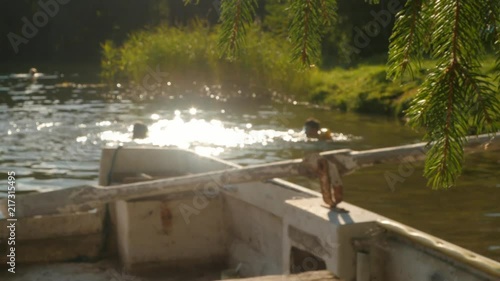 anoymous children in lake, splashing water, summer, golden hour, in paradise photo