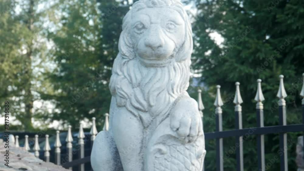 plaster, concrete figurine of a lion on the gate of the residence plaster, concrete figurine of a lion on the gate of the residence