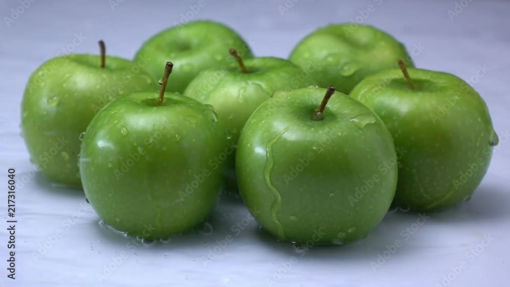 water splashing on a apple fruit in slow motion. water splashing on a apple fruit in slow motion.