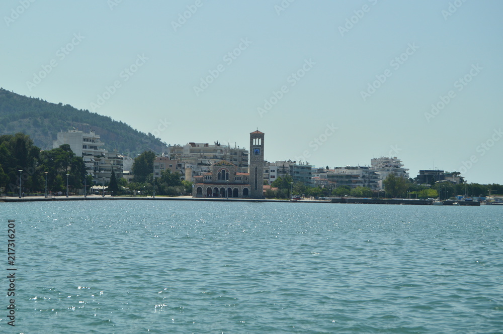 Orthodox Church Of Konstantinos On Its Main Facade Photo Taken With The Sea In Between Enhancing Its Beauty. Architecture History Travel.4 July 2018. Volos. Magnesia. Greece.