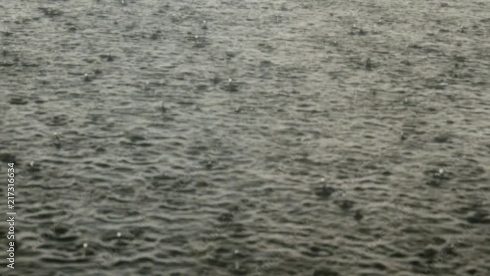 heavy drops of rain on the surface of water, lake, downpour heavy drops of rain on the surface of water, lake, downpour