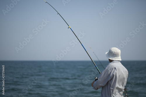 Fishermen sea coast water in white clothes and hat