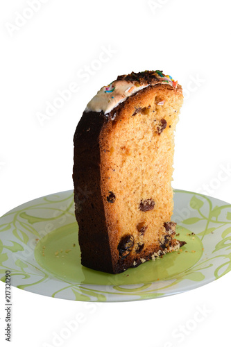 Burnt piece of cake with raisins. White background