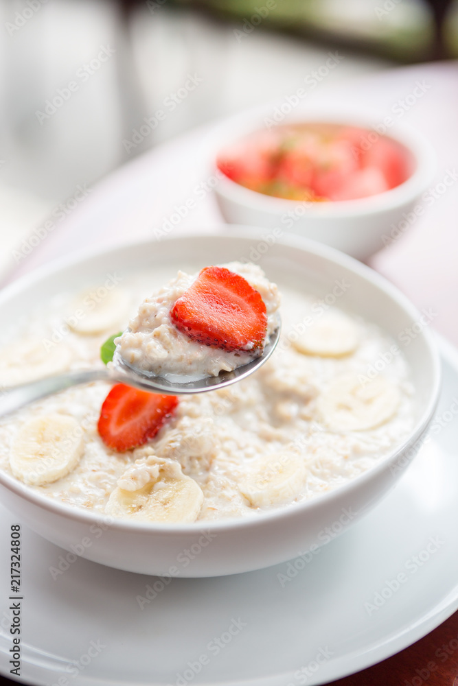 Tasty and healthy oatmeal porridge with fruit, berry,strawberry, banana and flax seeds. Healthy eating lifestyle concept. Health care and beauty. Healthy breakfast. Fitness food. Proper nutrition. Tasty and healthy oatmeal porridge with fruit, berry,strawberry, banana and flax seeds. Healthy eating lifestyle concept. Health care and beauty. Healthy breakfast. Fitness food. Proper nutrition.