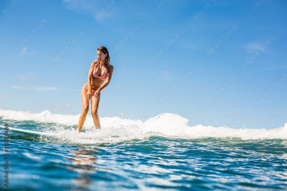 Fitness surfer woman in sexy bikini on surfing longboard ride and have fun  on big waves