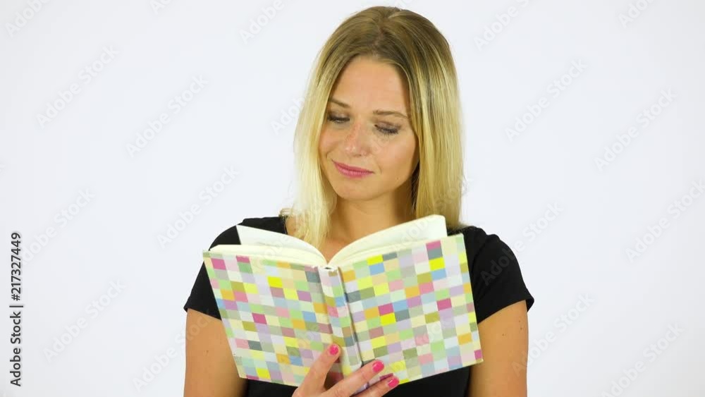A young beautiful woman reads a book - white screen studio A young beautiful woman reads a book - white screen studio