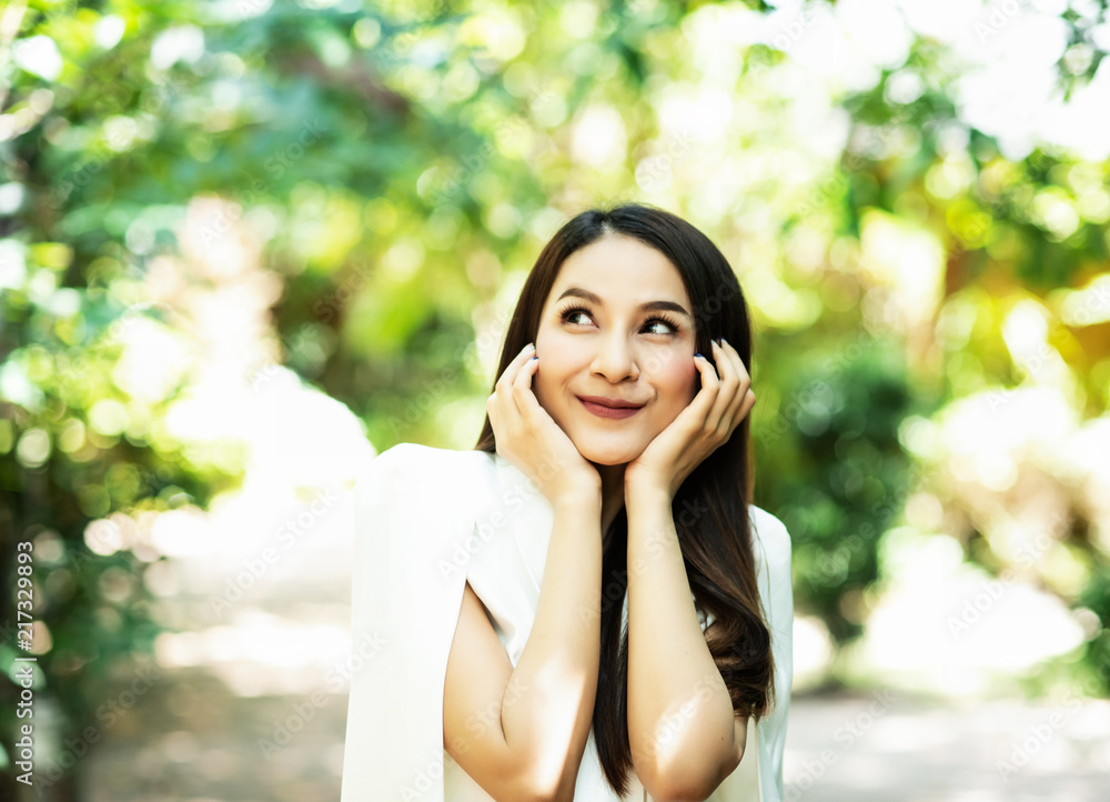 The beauty lady is looking and turn face up,with smile and happy feeling,blurry light around The beauty lady is looking and turn face up,with smile and happy feeling,blurry light around