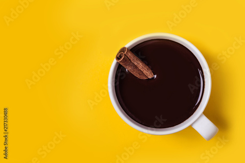 Hot chocolate cup with cinnamon. Warming winter or autumn drink concept