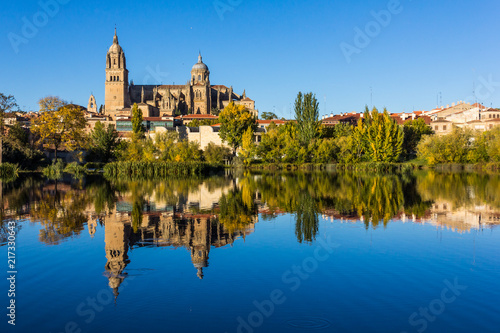 Cityscape of Salamanca and its mirror image on Tormes river (Spain)