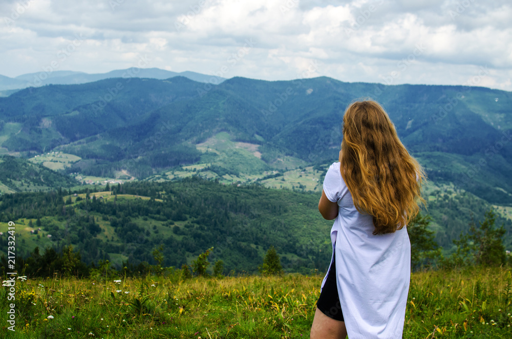 A young girl loves to travel and conquer the peaks of the mountains A young girl loves to travel and conquer the peaks of the mountains