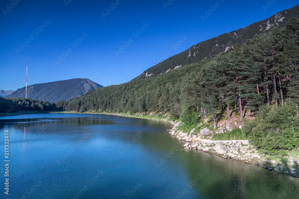 Mountain Lake in Andorra. Coniferous forest