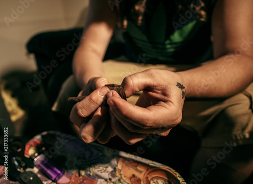 A Man Rolling A Blunt