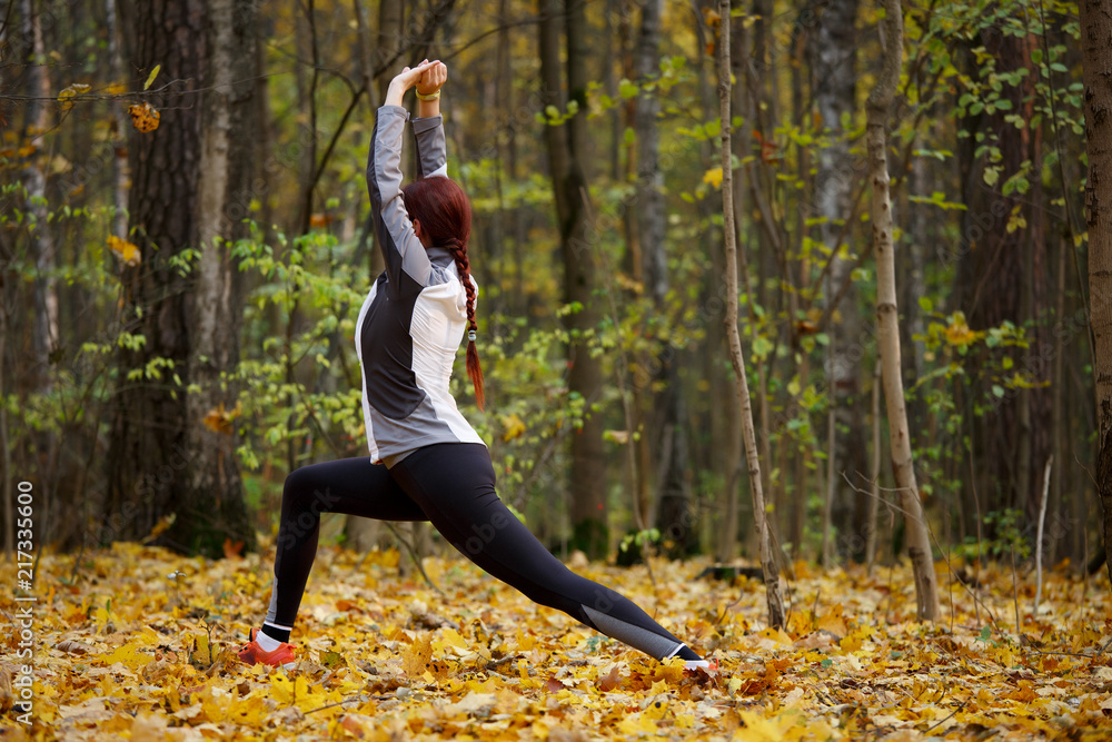 Image of sports fitness girl doing stretching exercises in fresh air