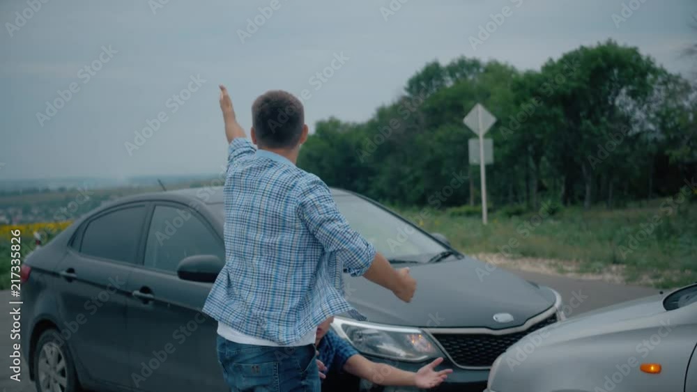 Two drivers argue about blame for accident by the side of damaged. Two male drivers argue over who is to blame for traffic accident. The concept of traffic. Two drivers argue about blame for accident by the side of damaged. Two male drivers argue over who is to blame for traffic accident. The concept of traffic.