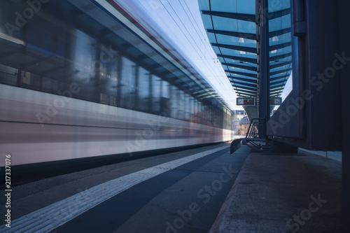 Moving tram train driving through a train station moving public transport