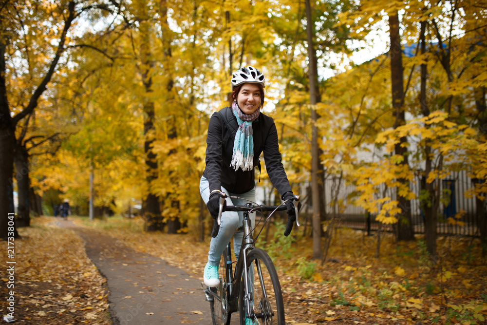 Photo of woman in helmet riding bicycle along path Photo of woman in helmet riding bicycle along path