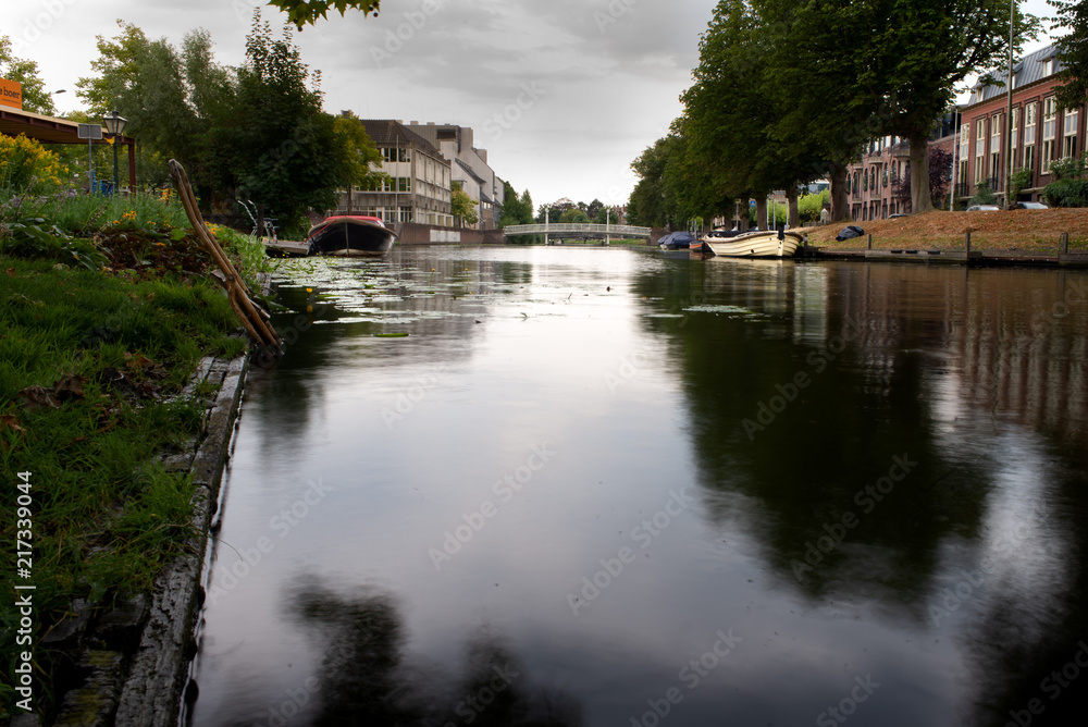Fototapeta premium Reflection of the sky and typical Dutch houses in canal water
