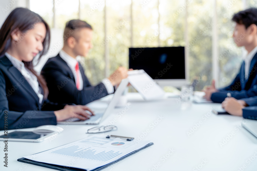 Young business people are presented marketing work project to the customer in meeting room office , Pic focus at paper graph Young business people are presented marketing work project to the customer in meeting room office , Pic focus at paper graph