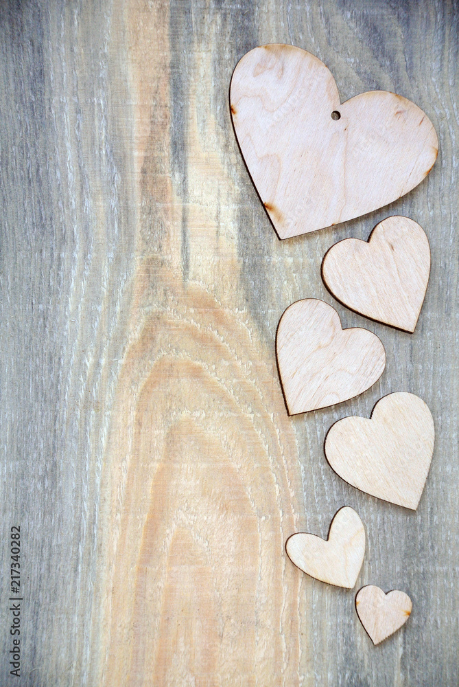 Obraz premium pattern of wooden hearts on a wooden background