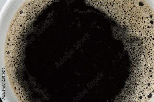 White Cup of black coffee, close up. Top view