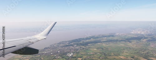 Aerial View of Bristol City Center in England, UK and surrounding fields. On the left the airplane wing.