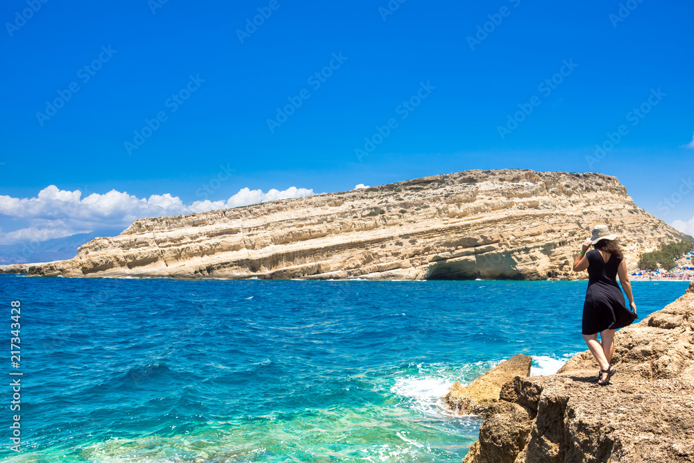 Matala beach with caves on the rocks that were used as a roman cemetery and at the decade of 70's were living hippies from all over the world, Crete, Greece